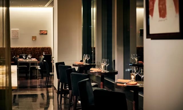 Sophisticated Park Hotel Tokyo restaurant with elegant table settings for corporate networking.