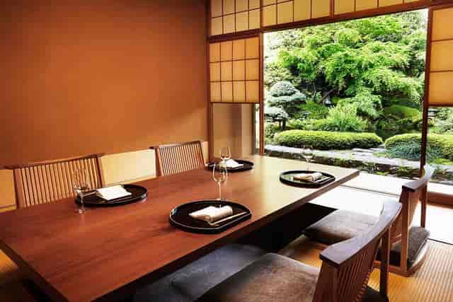 Private dining room at Unkai Japanese Restaurant with tranquil garden view for corporate meetings.