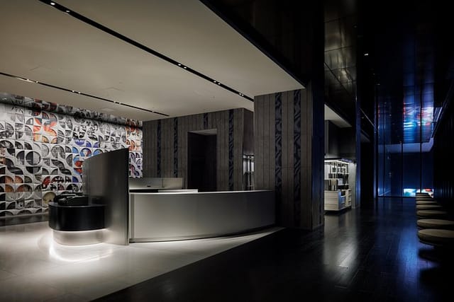 Contemporary event registration area at HOTEL GROOVE SHINJUKU with sleek minimalist desk.