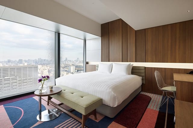 Contemporary hotel room with city views at Hotel Groove Shinjuku for corporate business travel.