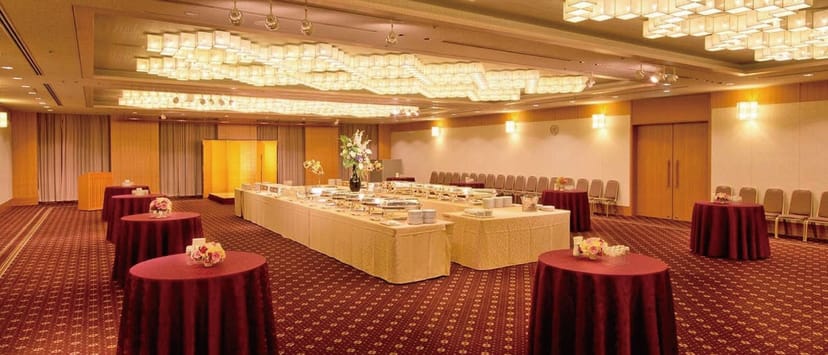 Toshi Center Hotel ballroom with chandeliers, setup for elegant banquet and gala event.