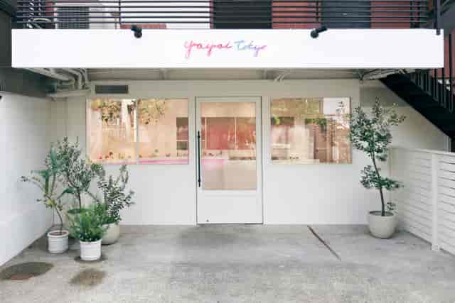 Minimalist Yayoi boutique storefront for exclusive VIP activation or brand pop-up event.