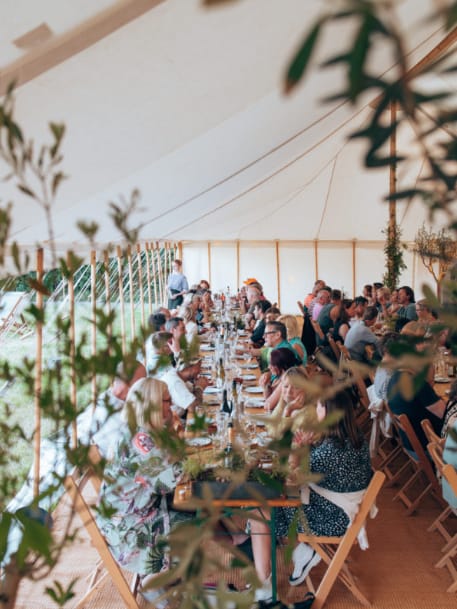 Yurtel glamping long-table marquee for outdoor weddings and corporate events.