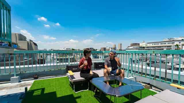 Hotel Graphy Nezu rooftop bar with city skyline, ideal for networking and outdoor corporate events.