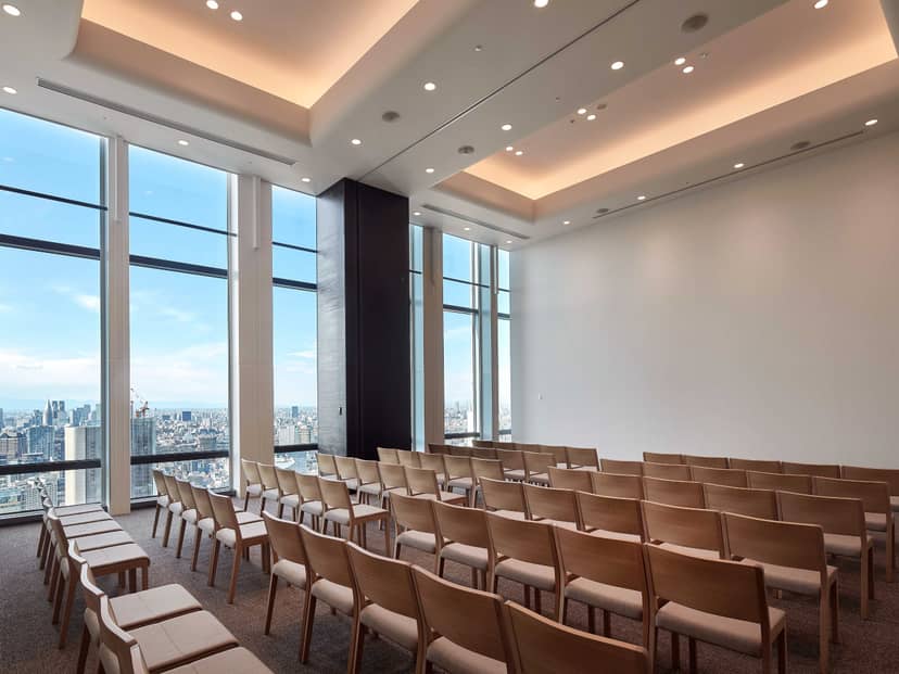 Tokyo Toranomon Global Square theater-style conference room with panoramic city view.