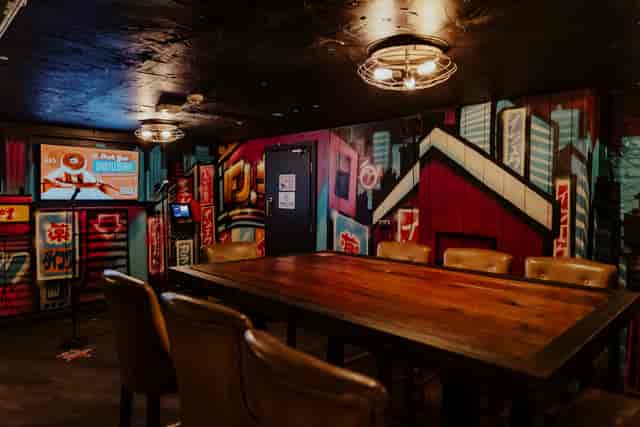 Karaoke Room at Roxy Ball Room, Leeds with urban graffiti and large wooden table for meetings.