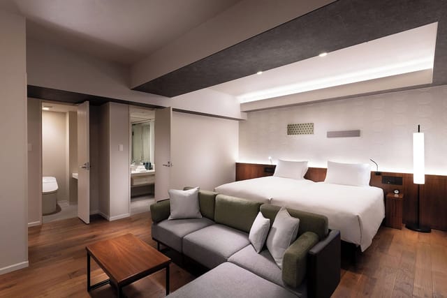 Modern DoubleTree Tokyo Ariake executive meeting room with minimalist lounge for corporate events.