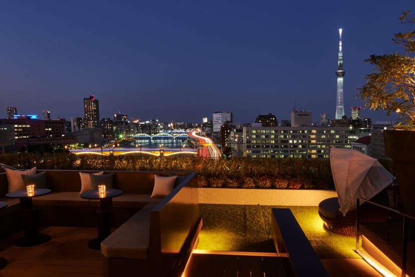 Rooftop networking reception at THE GATE HOTEL Ryogoku with Tokyo skyline views.