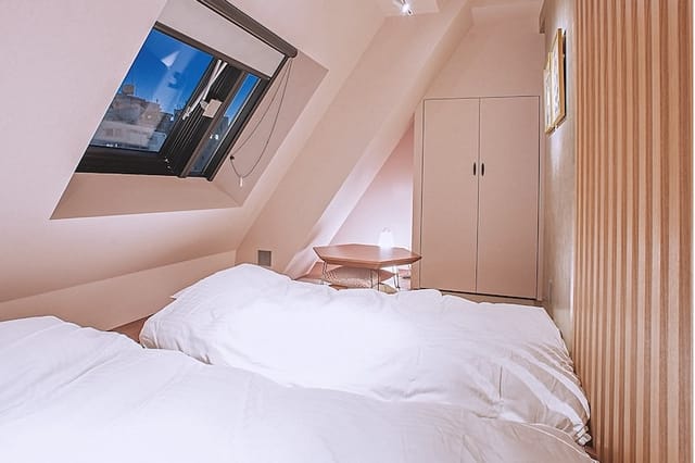 Kutani hotel room in Asakusa Kaede with low attic ceilings for budget travel and event lodging.