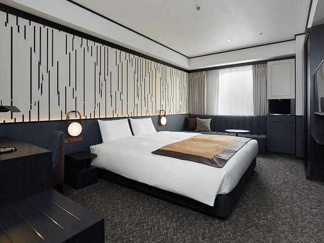 Premium hotel guest room with workspace for corporate travel and conference incentive bookings.