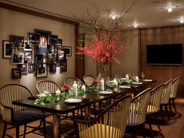 Private dining room at NAMIKI667 Tokyo with floral decor for business meetings and celebrations.