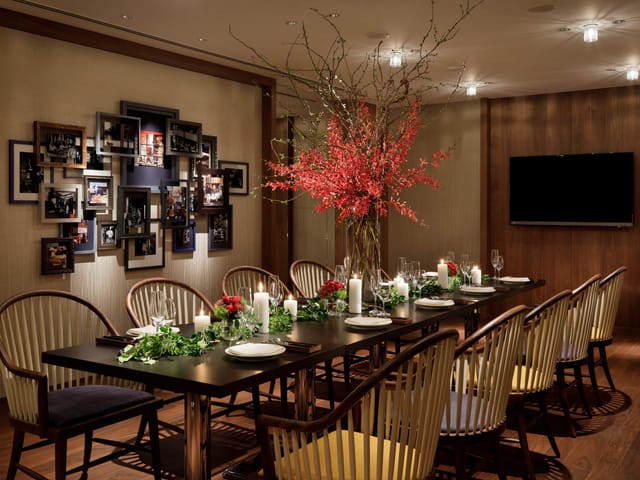Private dining room at NAMIKI667 Tokyo with floral decor for business meetings and celebrations.