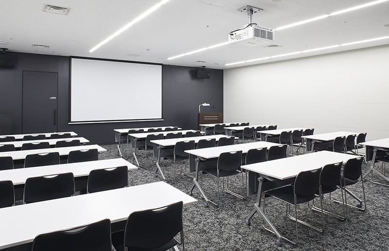 Classroom-style meeting room at Tourism EXPO Japan for corporate training and seminars.