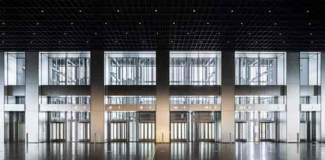 Modern TOKYO NODE lobby with industrial aesthetic for corporate events and registration venues.