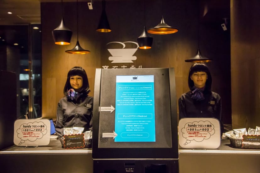 High-tech robot registration desk at Henn na Hotel Ginza for efficient corporate event check-in.
