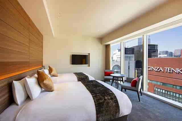 Modern twin guest room at karaksa hotel Tokyo Ginza for business travel and conference stays.