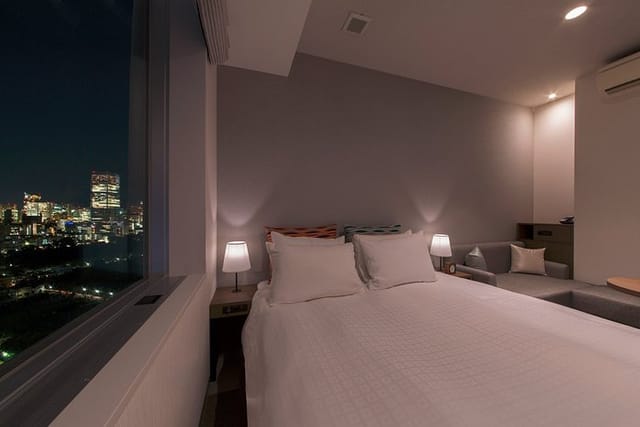 Luxury hotel lounge with city skyline view, ideal for executive travel and VIP room blocks.