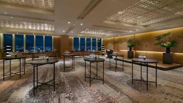 Cocktail reception at Applause Square Tokyo with high-top tables and cityscape view.