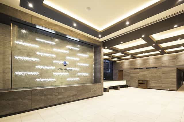 Modern hotel lobby meeting room with water feature, ideal for brand activations and networking.