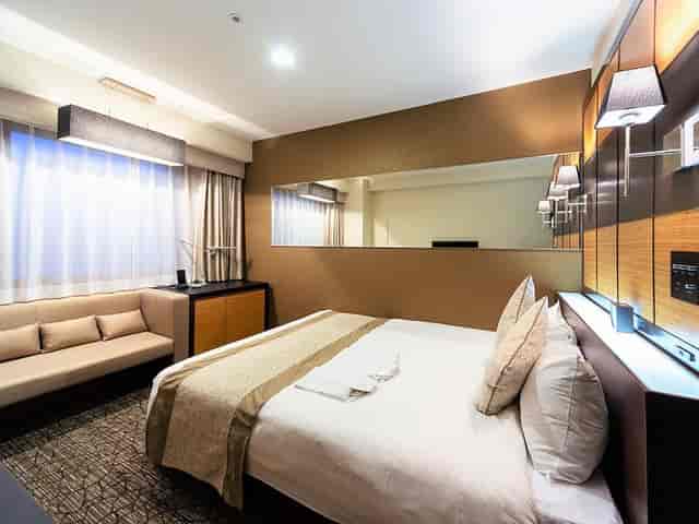 Hotel Wing International Tokyo Yotsuya guest room with desk for business travel conference stay.