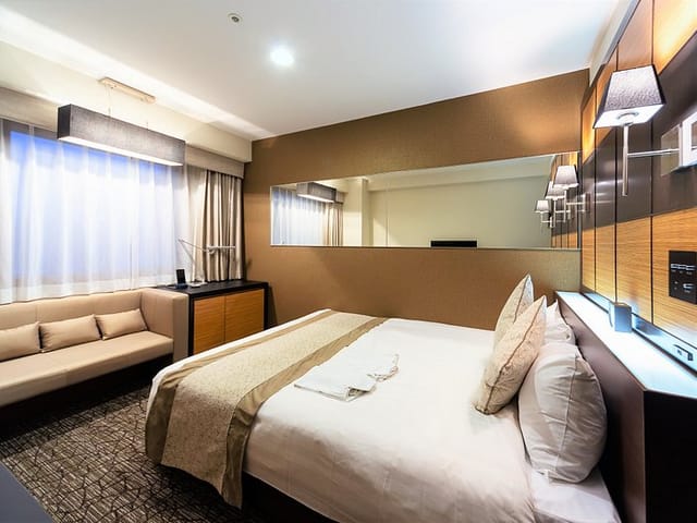 Hotel Wing International Tokyo Yotsuya guest room with desk for business travel conference stay.