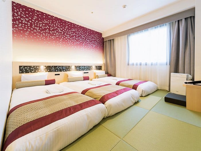 Triple-occupancy room at Hotel Wing International Premium Tokyo Yotsuya for group travel events.