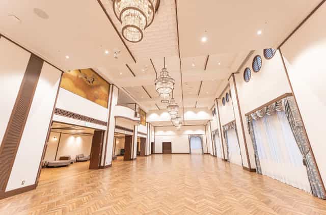 Elegant ballroom with high ceilings and chandeliers for upscale galas and corporate conferences.