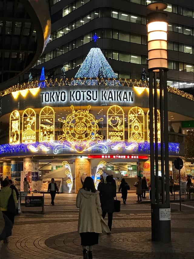 Tokyo Kotsu Kaikan gallery exterior with festive evening lighting for corporate holiday events.