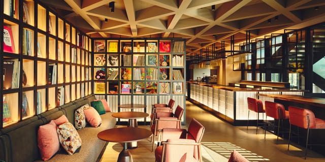 Sophisticated breakout space with library wall for professional networking and corporate events.