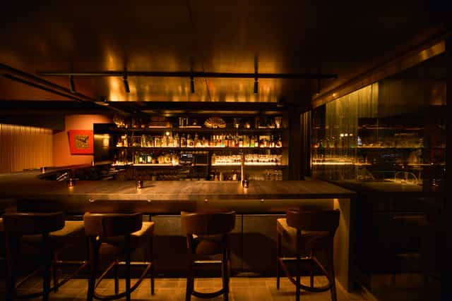 Moody hotel lounge for high-end corporate networking reception and professional event.