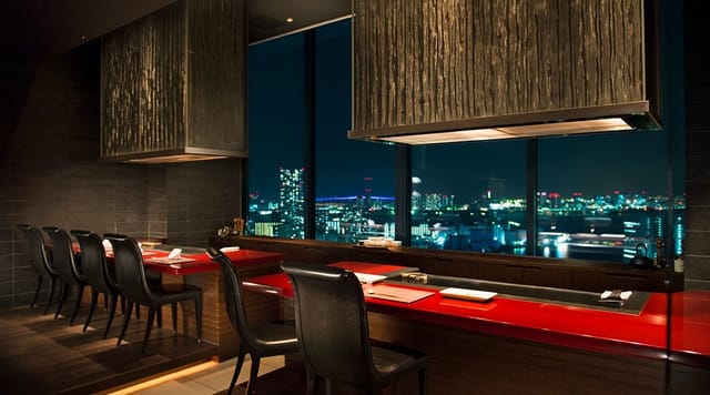 Kazahana Teppanyaki dining space with city views for VIP client dinners and incentive networking.