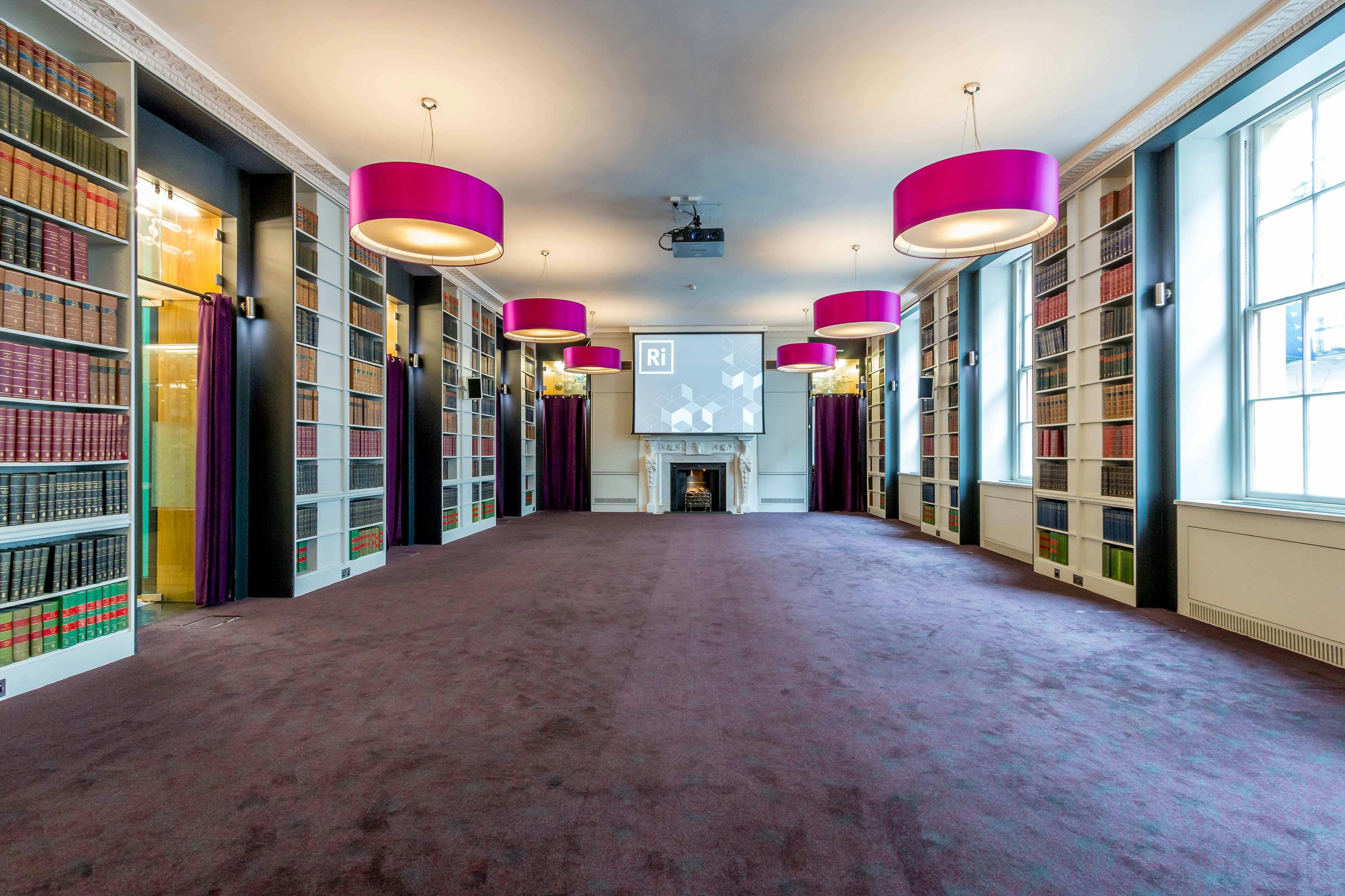 Elegant meeting space with pink lighting, ideal for corporate events and presentations.