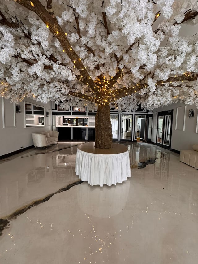 Illuminated cherry blossom tree centerpiece in Fleur Ballroom for weddings and events.