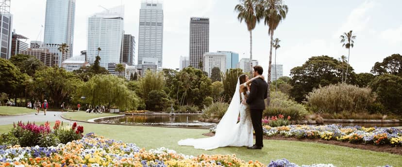 Luxury garden wedding venue with urban skyline backdrop for corporate events.