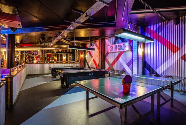 Vibrant event space with ping pong tables at Roxy Ball Room, ideal for corporate gatherings.