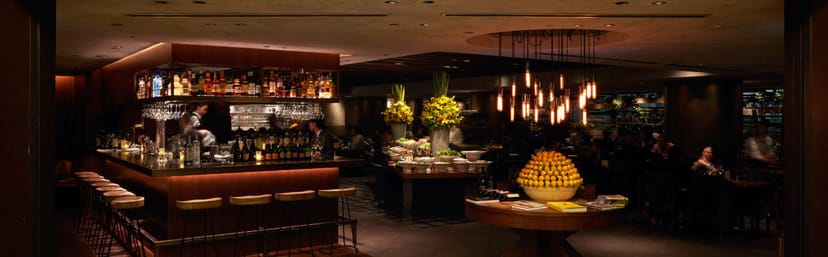 Roppongi Barbacoa upscale networking reception with elegant bar and warm lighting.