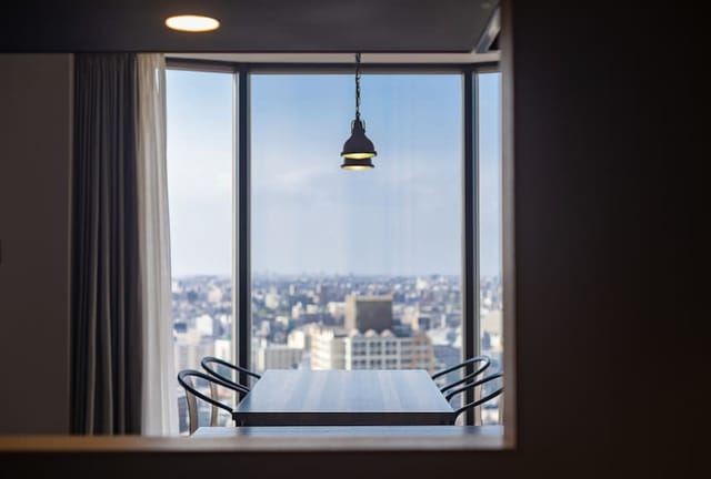 Executive boardroom at Hundred Stay Tokyo Shinjuku with skyline view for corporate meetings.