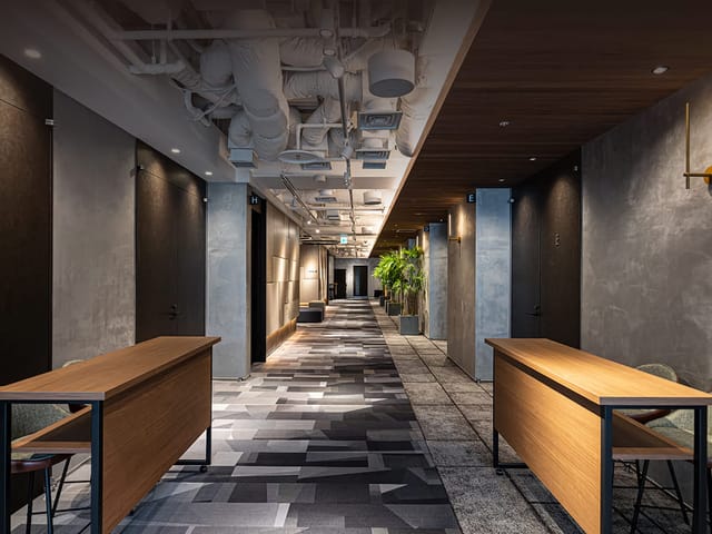 Modern industrial pre-function area at AP Shinagawa for corporate meetings and event registration.