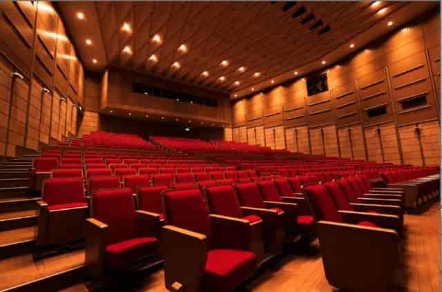 E Hall auditorium with red tiered seating for corporate keynotes and large-scale presentations.