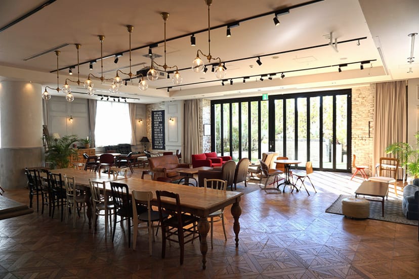 TRUNK BY SHOTO GALLERY industrial event space with banquet tables for workshops and networking.