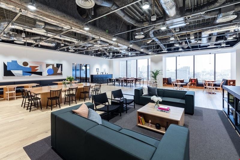 Industrial-chic Tokyo coworking space with lounge seating for networking and collaborative meetings.