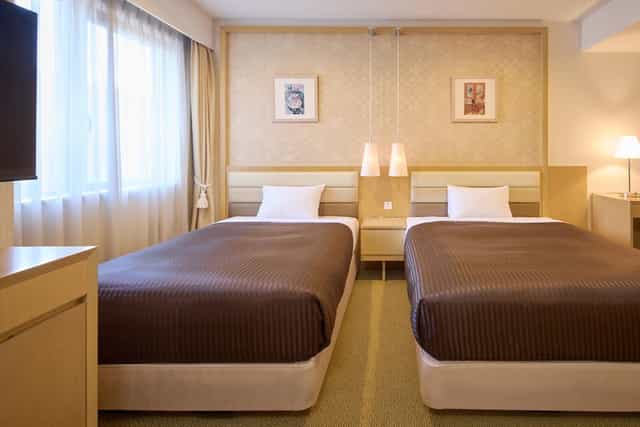 Standard twin guest room at The OneFive Tokyo Kameido for business travel and conference lodging.