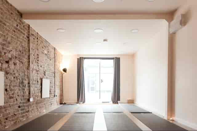 Stoke Newington Studio: Industrial-chic exposed brick space for wellness workshops and meetings.