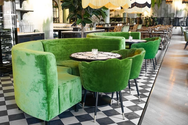 Plush velvet banquettes in Ravintola Kiila for intimate corporate events and VIP networking.
