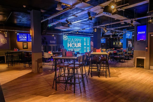 Industrial Bierkeller Birmingham event venue with high-top seating for networking and social events.