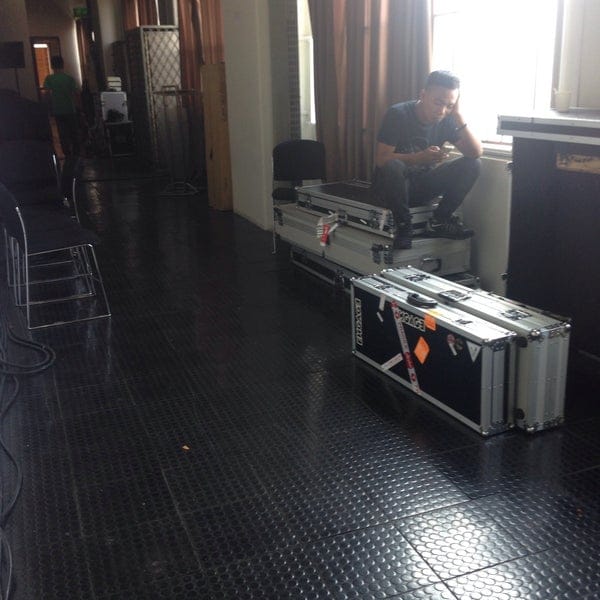 Technician resting in Upperroom Jakarta Annex Room 8 after event strike and gear load-out.