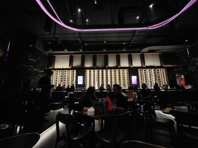 Elegant Holywings bar with architectural lighting for corporate networking and evening receptions.