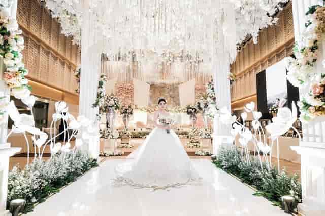Luxury wedding ballroom with grand floral arch for high-end event decor and venue inspiration.