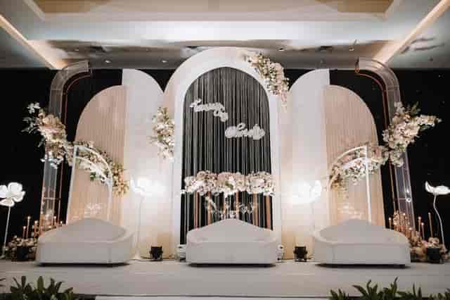 VIDA Ballroom stage design with arched backdrops and floral accents for corporate event gala.