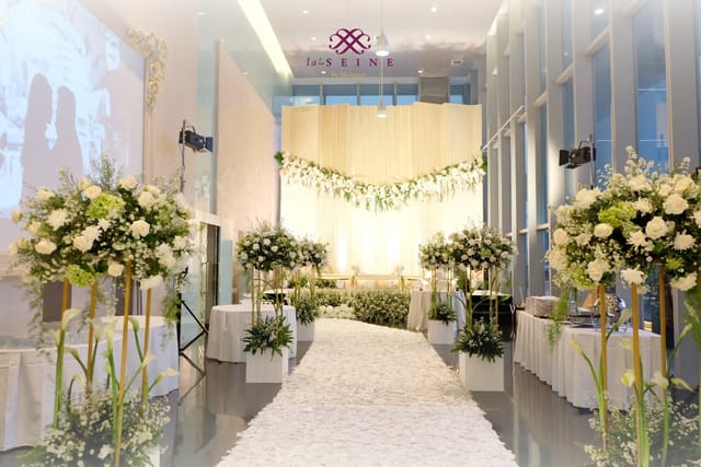 La Seine Hall wedding ceremony with white floral decor and elegant lighting for elegant events.